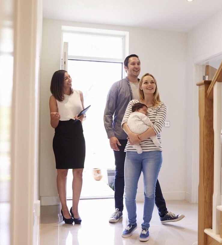 real estate agent showing home to buyers