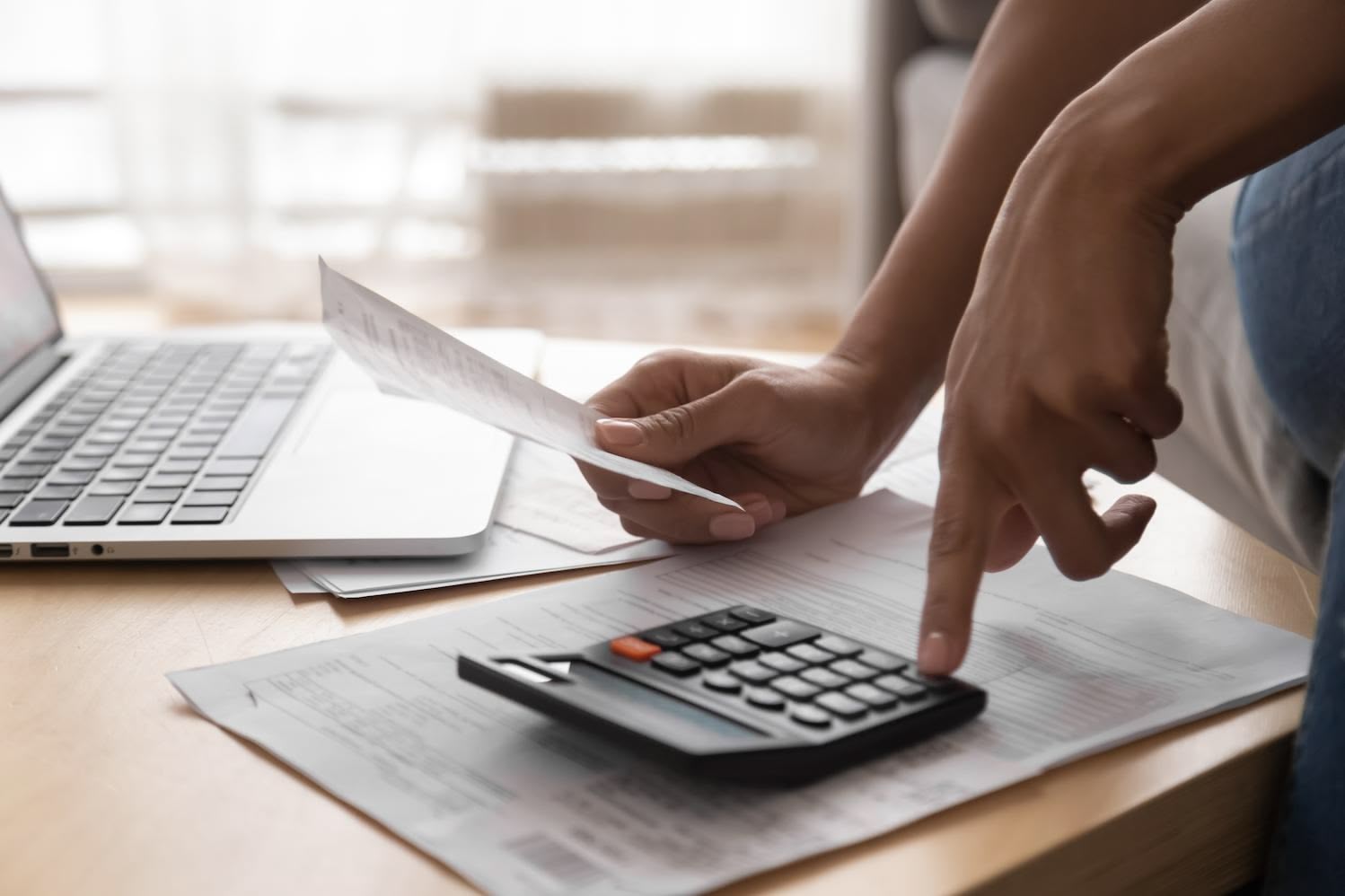 hands using documents and a calculator